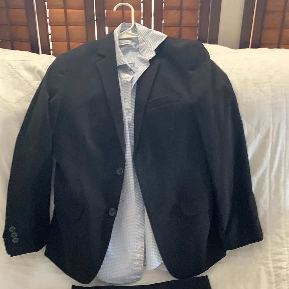 Boys size 14 Calvin Klein black suit with blue and white shirt.